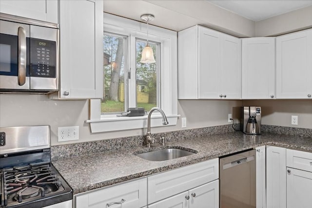 kitchen with a sink, white cabinets, and stainless steel appliances