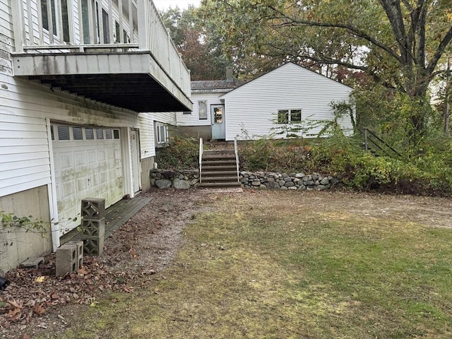 view of yard with stairway and an attached garage