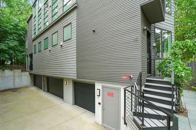 95 Kirkland St Unit 95, Cambridge, MA 02138 - view of building exterior with a garage and driveway