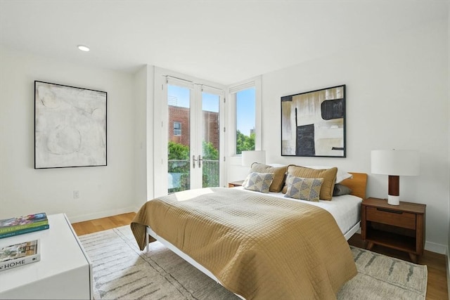 95 Kirkland St Unit 95, Cambridge, MA 02138 - bedroom with access to exterior and wood finished floors