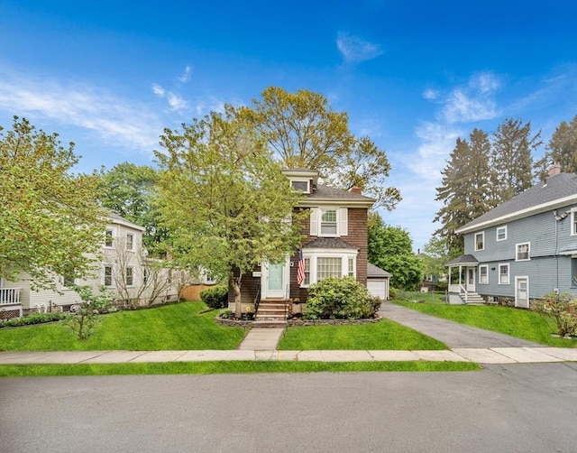 98 Haseltine St, Haverhill, MA 01835 - view of front of house with entry steps, an outbuilding, a chimney, a front lawn, and a detached garage