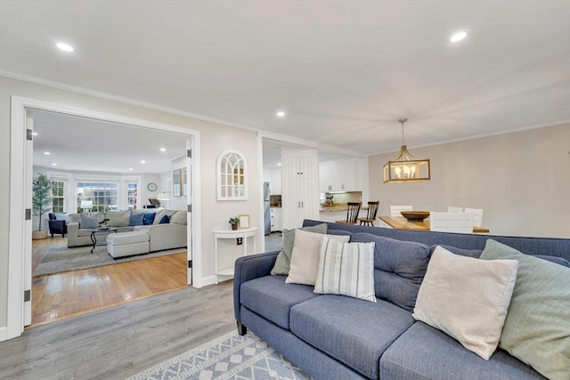 98 Haseltine St, Haverhill, MA 01835 - living room featuring recessed lighting, light wood-style flooring, crown molding, a chandelier, and baseboards