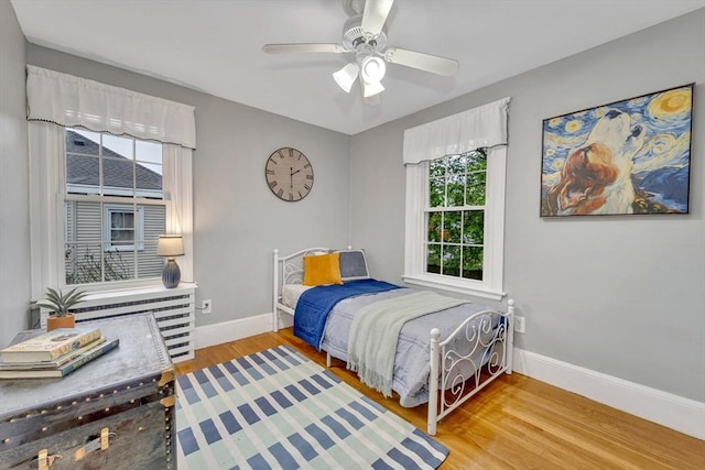 98 Haseltine St, Haverhill, MA 01835 - bedroom with multiple windows, baseboards, wood finished floors, and a ceiling fan