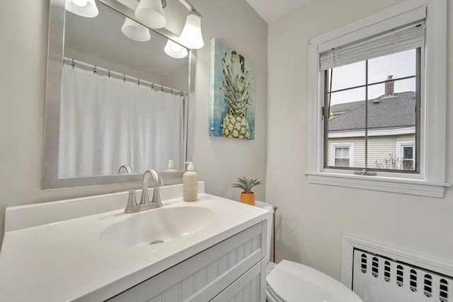 98 Haseltine St, Haverhill, MA 01835 - bathroom featuring radiator heating unit, vanity, and toilet