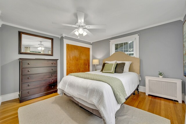 98 Haseltine St, Haverhill, MA 01835 - bedroom featuring radiator heating unit, crown molding, wood finished floors, baseboards, and a ceiling fan