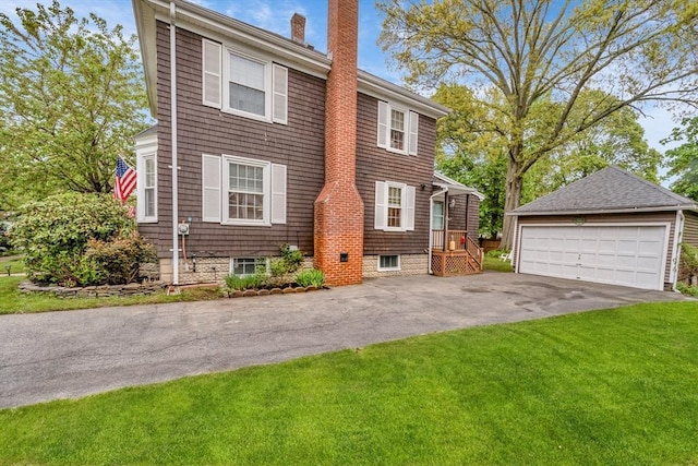 98 Haseltine St, Haverhill, MA 01835 - view of front facade featuring a chimney, a detached garage, a front yard, and an outdoor structure