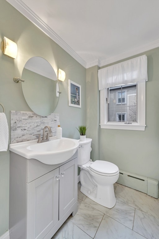 98 Haseltine St, Haverhill, MA 01835 - bathroom featuring baseboard heating, toilet, vanity, backsplash, and marble look tiles
