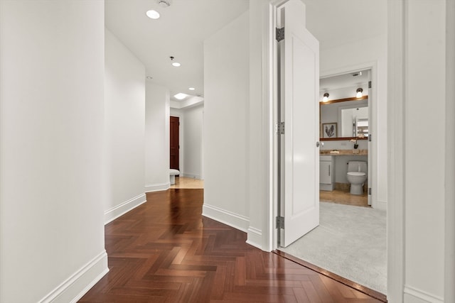 hallway featuring dark parquet floors