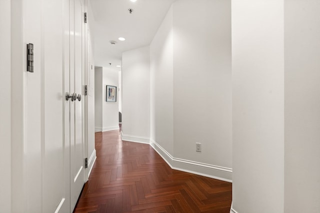 hallway featuring dark parquet floors