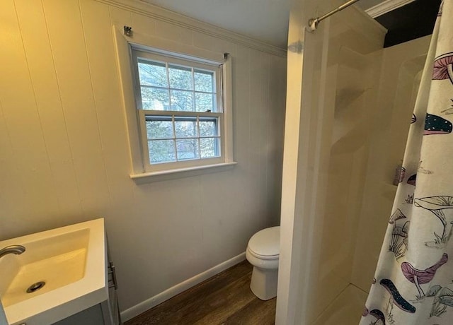 bathroom with curtained shower, wood-type flooring, vanity, toilet, and crown molding