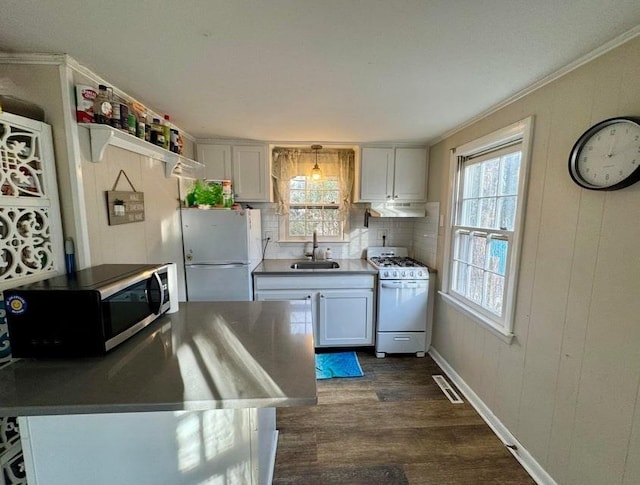 kitchen with dark wood-type flooring, sink, white cabinetry, crown molding, and white appliances