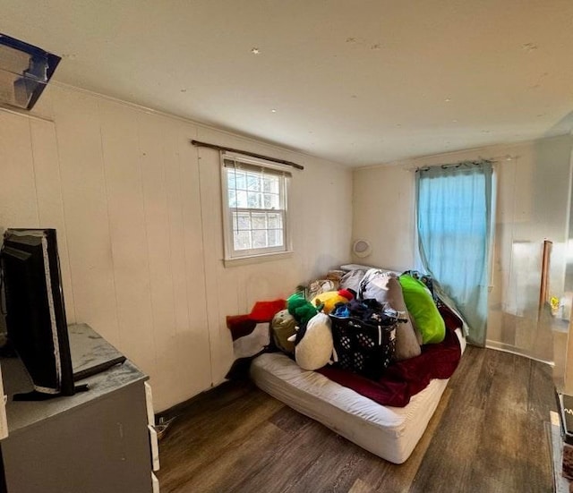 bedroom with dark wood-type flooring