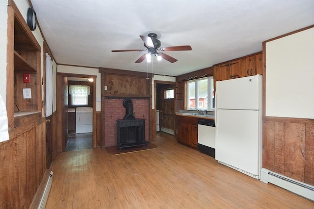 241 Fisher St, Walpole, MA 02081 - kitchen featuring white appliances, washer / dryer, a baseboard heating unit, a wood stove, and ceiling fan