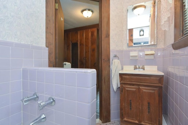 241 Fisher St, Walpole, MA 02081 - bathroom featuring wallpapered walls, vanity, wainscoting, tile walls, and a bathtub