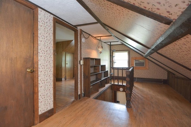 241 Fisher St, Walpole, MA 02081 - additional living space featuring wallpapered walls, wood finished floors, and a wall mounted AC
