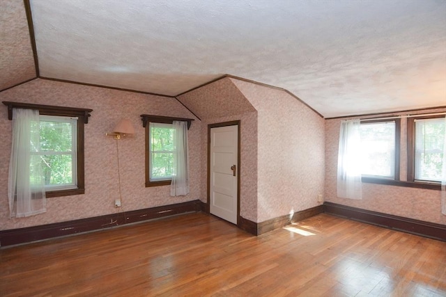 241 Fisher St, Walpole, MA 02081 - bonus room with lofted ceiling, wood finished floors, a textured ceiling, and wallpapered walls