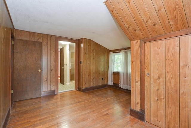 241 Fisher St, Walpole, MA 02081 - unfurnished bedroom featuring wood finished floors, lofted ceiling, and wooden walls