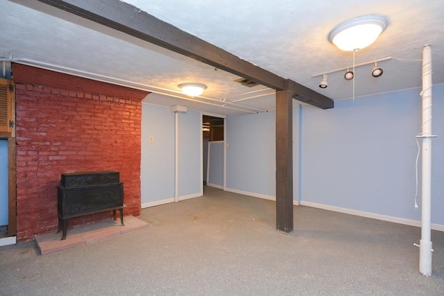 241 Fisher St, Walpole, MA 02081 - finished below grade area featuring a wood stove and baseboards