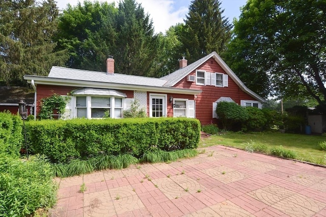 241 Fisher St, Walpole, MA 02081 - view of front of home featuring a chimney, a patio, and a front yard