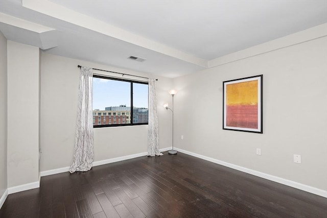 unfurnished room featuring wood finished floors and baseboards