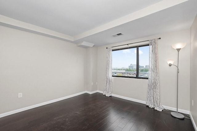 unfurnished room featuring hardwood / wood-style floors and baseboards