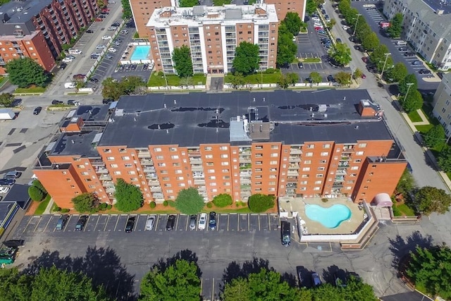 aerial overview of property's location featuring a pool and apartment complex / building