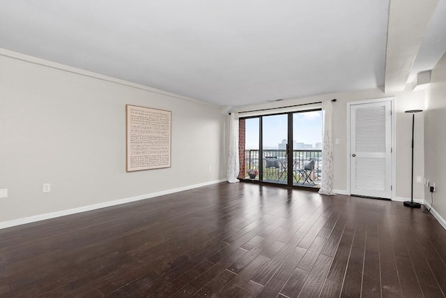 unfurnished living room with dark wood-style floors and baseboards