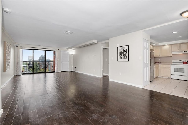 unfurnished living room with baseboards and light wood-style flooring