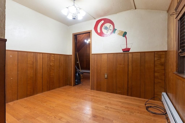 18 Balder Rd, Worcester, MA 01605 - unfurnished room with a baseboard radiator, vaulted ceiling, wood finished floors, wood walls, and wainscoting