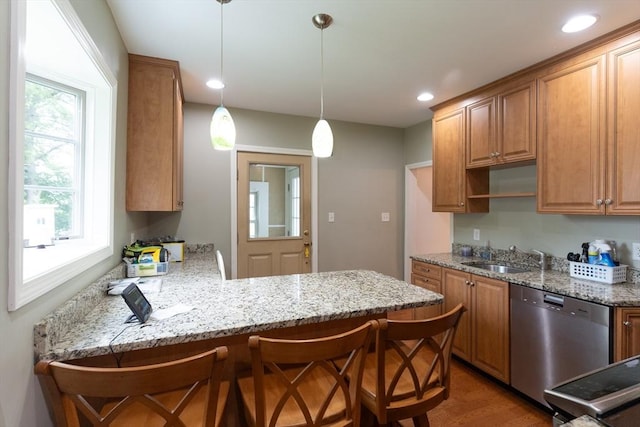 18 Balder Rd, Worcester, MA 01605 - kitchen featuring stainless steel dishwasher, a peninsula, wood finished floors, a breakfast bar area, and light stone countertops