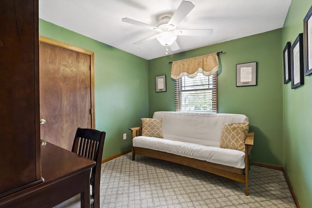 home office with baseboards, ceiling fan, and light colored carpet