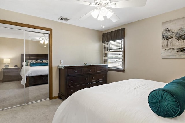 bedroom featuring light colored carpet, a closet, and ceiling fan