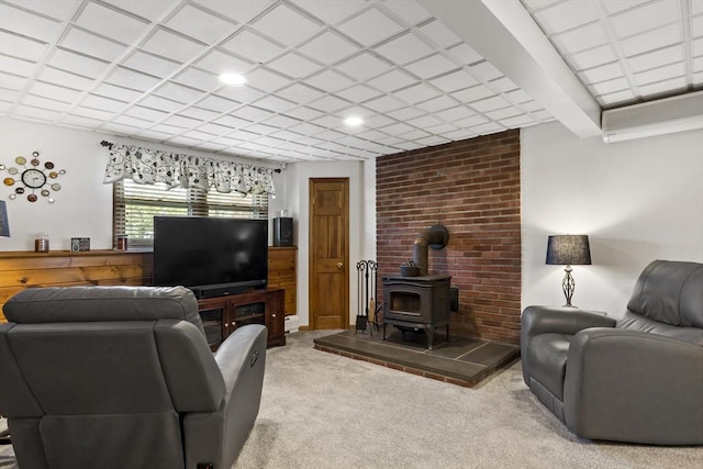 carpeted living area with a wood stove