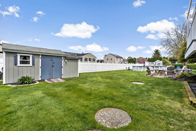view of yard featuring a shed and an outdoor structure