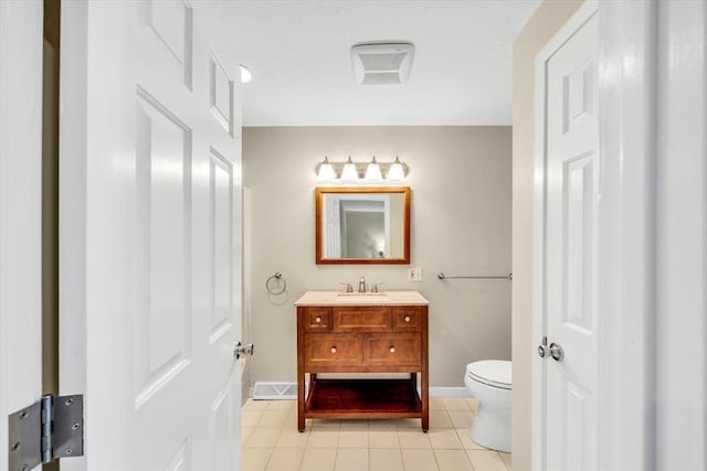 bathroom with visible vents, toilet, vanity, tile patterned flooring, and baseboards