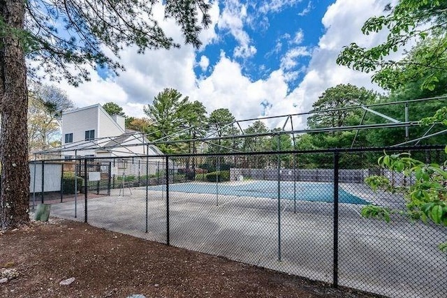 view of sport court featuring fence