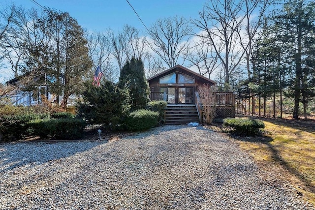 view of front of house with driveway and a wooden deck