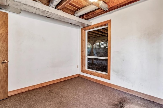 spare room featuring carpet flooring and baseboards