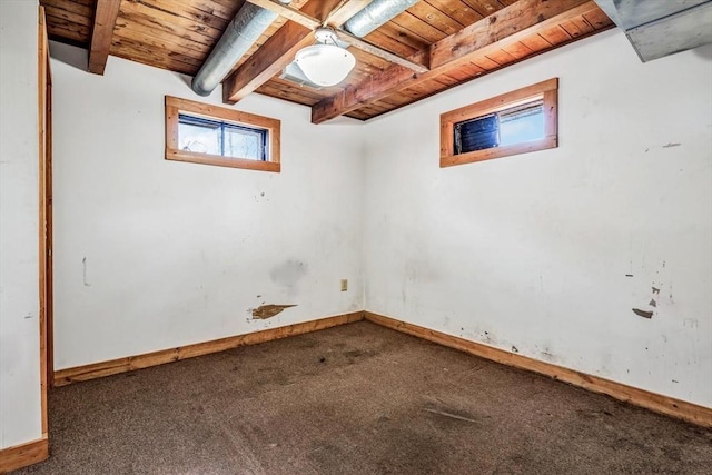 below grade area featuring wood ceiling, baseboards, and carpet flooring