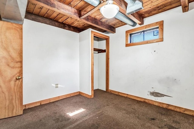 basement with wooden ceiling, carpet flooring, and baseboards