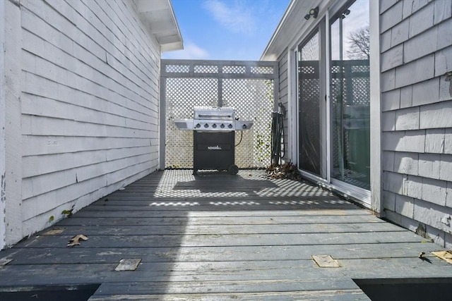 wooden deck featuring a grill