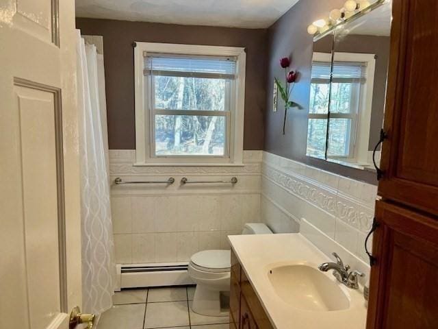 bathroom with tile patterned flooring, a wealth of natural light, toilet, and baseboard heating