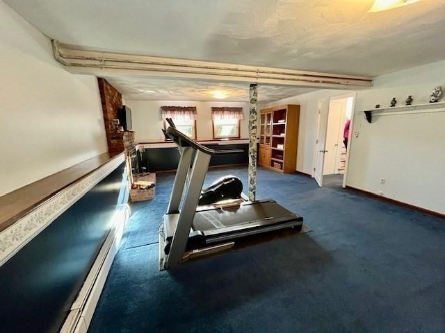 exercise area featuring dark colored carpet