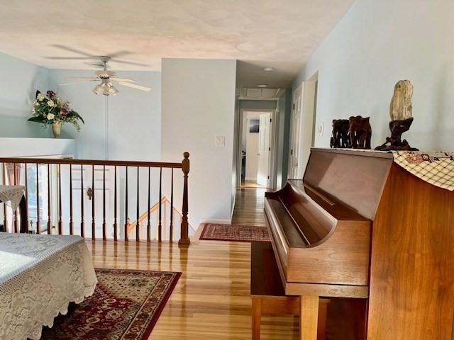 interior space with hardwood / wood-style floors and ceiling fan