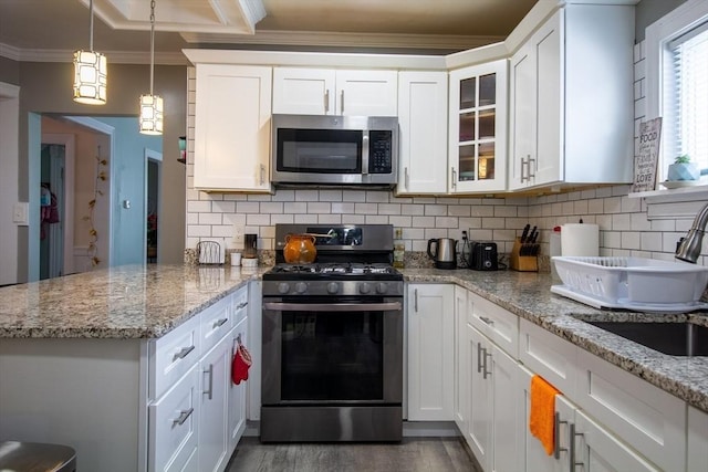 kitchen featuring tasteful backsplash, white cabinets, and appliances with stainless steel finishes