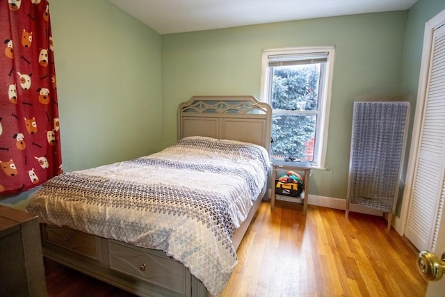 bedroom featuring a closet and light hardwood / wood-style flooring