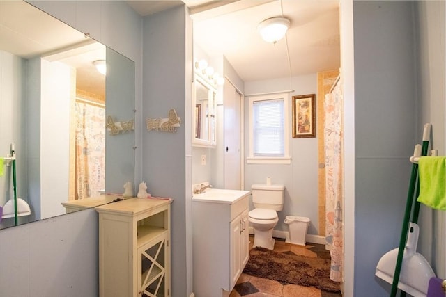 bathroom featuring toilet and vanity