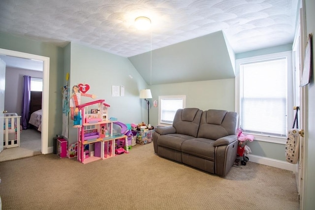 rec room featuring lofted ceiling and light carpet