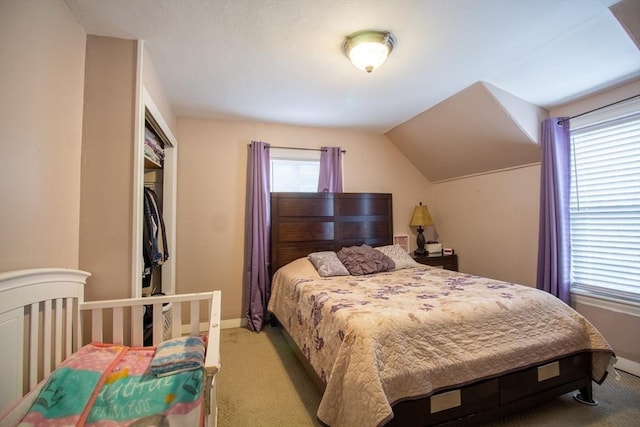 bedroom featuring lofted ceiling and light colored carpet