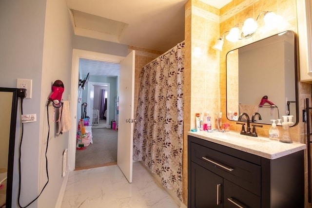 bathroom featuring tile walls, a shower with curtain, and vanity